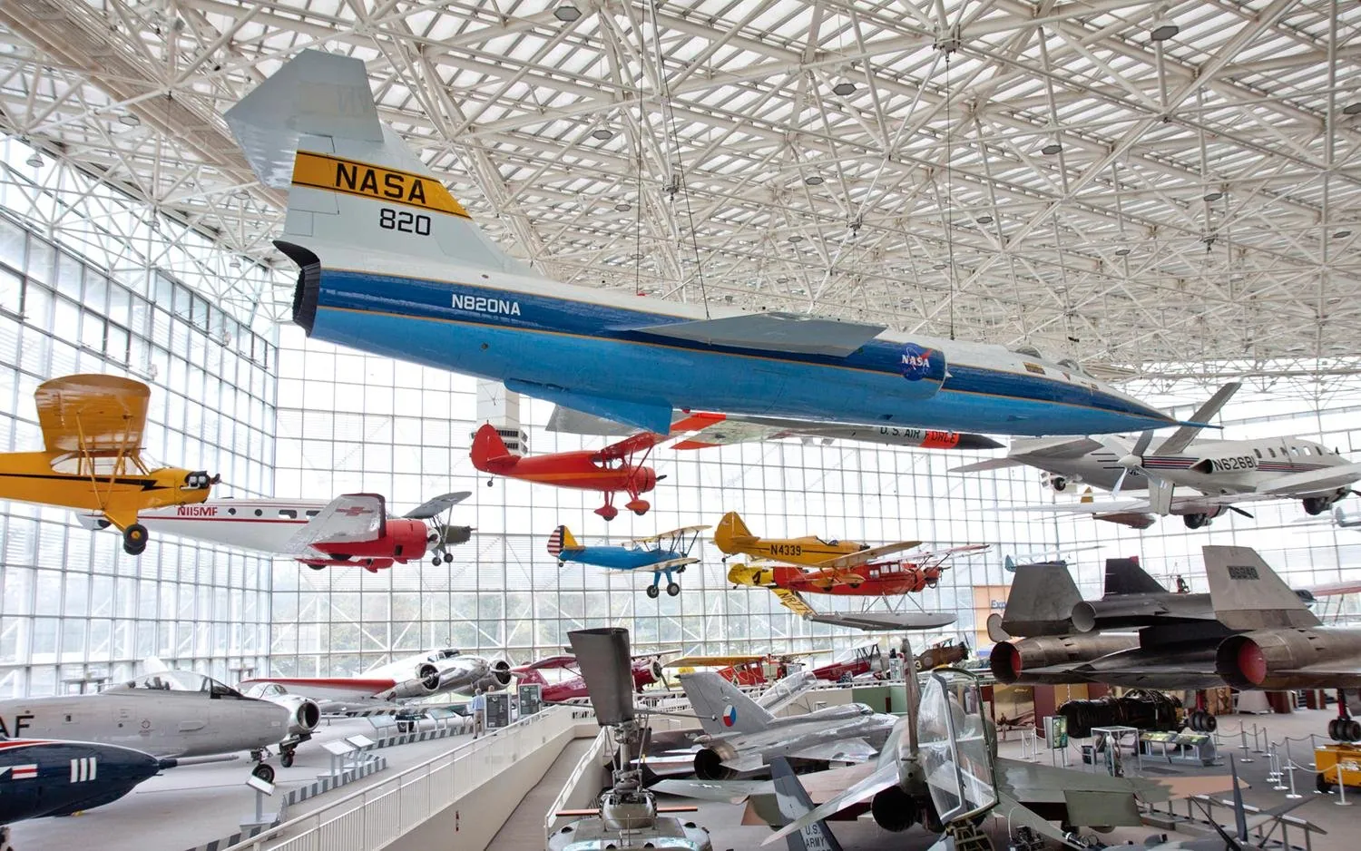 A NASA jet and brightly painted biplanes hanging from the steel-and-glass roof of the Great Gallery