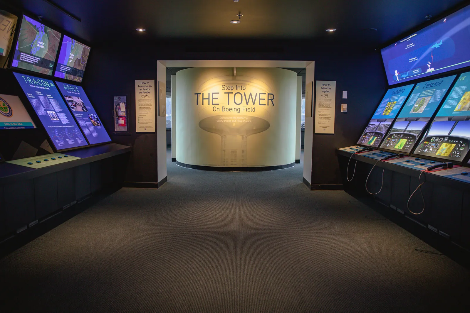 The entrance to The Tower on Boeing Field exhibit, lined with live air-traffic screens